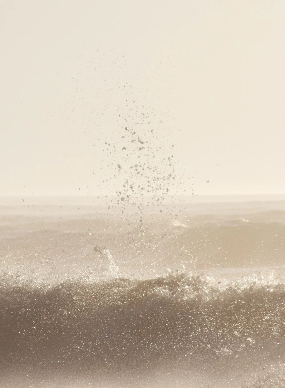 Waves breaking and water splashing into the air